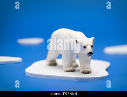 A conceptual illustration showing a polar bear trapped on a melting piece of ice in the Arctic Stock Photo