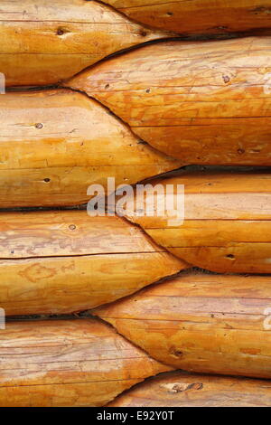 intersection, round wood beams on exterior wall of a lodge Stock Photo