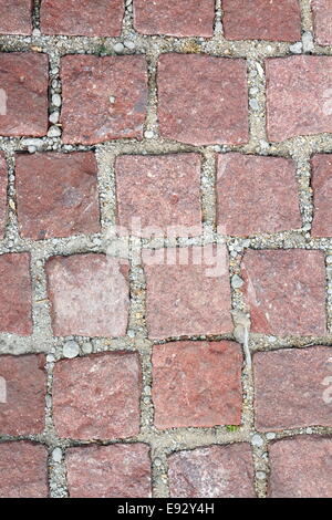 old reddish stone pavement mounted on gravel Stock Photo