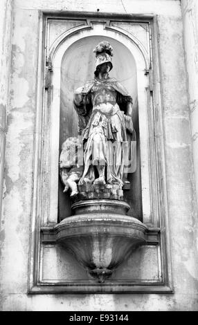 Religious statue on a church facade in Venice, Italy Stock Photo