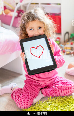 portrait of a little girl with a Digital tablet Stock Photo