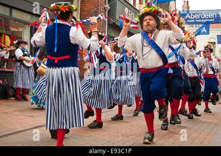 Horizontal portrait of traditional North-West Morris dancers performing a formation dance Stock Photo