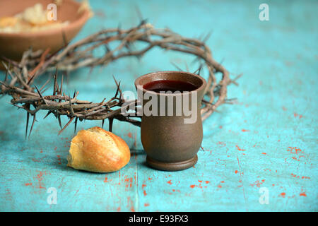 Bread, wine and crown of thorns on vintage table Stock Photo