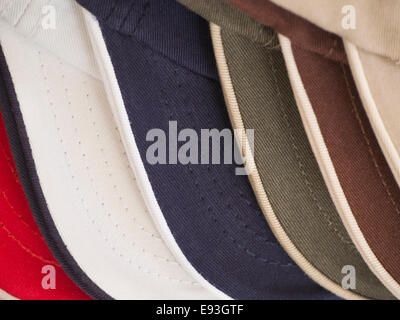 close up of sun shade on baseball caps ready for tourists on summer holiday in Greece Stock Photo