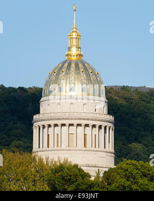 Golden West Virginia State Capital Dome towering above the trees on an early Fall evening, at sunset in Charleston, WV, USA Stock Photo