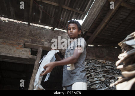 Dhaka, Bangladesh. 18th Oct, 2014. A child name Nurul Alam age of 12 working at a tannery factory in Hazaribagh. Dhaka's Hazaribagh area, widely known for its tannery industry, has been listed as one of the top 10 polluted places on earth with 270 registered tanneries in Bangladesh, and around 90-95 percent are located at Hazaribagh employing 8,000 to 12,000 people. Leather production includes many operations with different exposures, which can be harmful for the health of the workers, and particularly be carcinogenic © Zakir Hossain Chowdhury/ZUMA Wire/Ģ����ý Live News Stock Photo