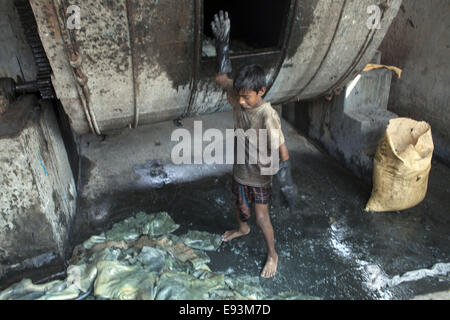 Dhaka, Bangladesh. 18th Oct, 2014. A child name Bahadur age of 11working at a tannery factory in Hazaribagh. Dhaka's Hazaribagh area, widely known for its tannery industry, has been listed as one of the top 10 polluted places on earth with 270 registered tanneries in Bangladesh, and around 90-95 percent are located at Hazaribagh employing 8,000 to 12,000 people. Leather production includes many operations with different exposures, which can be harmful for the health of the workers, and particularly be carcinogenic © Zakir Hossain Chowdhury/ZUMA Wire/Ģ����ý Live News Stock Photo