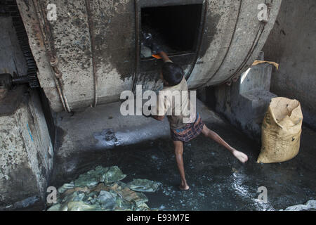 Dhaka, Bangladesh. 18th Oct, 2014. A child name Bahadur age of 11working at a tannery factory in Hazaribagh. Dhaka's Hazaribagh area, widely known for its tannery industry, has been listed as one of the top 10 polluted places on earth with 270 registered tanneries in Bangladesh, and around 90-95 percent are located at Hazaribagh employing 8,000 to 12,000 people. Leather production includes many operations with different exposures, which can be harmful for the health of the workers, and particularly be carcinogenic © Zakir Hossain Chowdhury/ZUMA Wire/Ģ����ý Live News Stock Photo