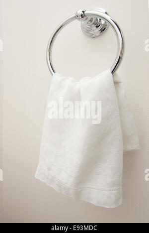 Close up of white hand towel on a Chrome towel bar. Stock Photo