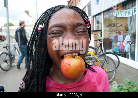 Children bob for apples at the Mill on Coppermill Lane in Walthamstow. A vibrant community centre hub, The annual Apple Day event at The Mill involves local families, children and elderly residents in apple bobbing, crafts, games and apple juice making with home-made apple inspired baked goods in Walthamstow East London UK  England  KATHY DEWITT Stock Photo