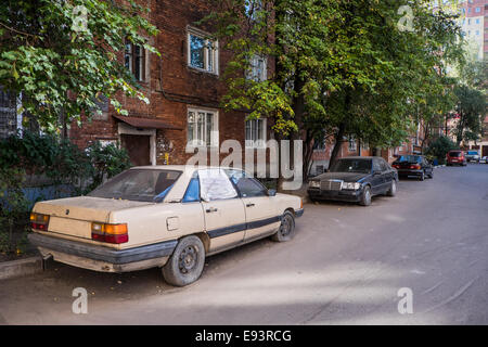 the Old dirty abandoned car flat tire Stock Photo