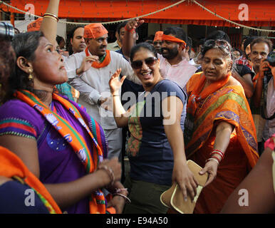 Mumbai, India. 19th Oct, 2014. Supporters of India's ruling Bharatiya Janata Party (BJP) celebrate as early results indicated the party leading in the Maharashtra state assembly elections in Mumbai, India, Oct. 19, 2014. India's ruling Bharatiya Janata Party (BJP) has won control of the country's financial capital Mumbai through a legislative election in the state of Maharashtra, while also grasping the northern state of Haryana from the Congress, said vote counting results Sunday. Credit:  Stringer/Xinhua/Alamy Live News Stock Photo