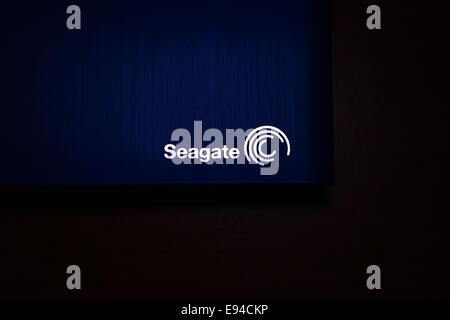 Blue Seagate external hard disk drive kept on a wooden desk Stock Photo