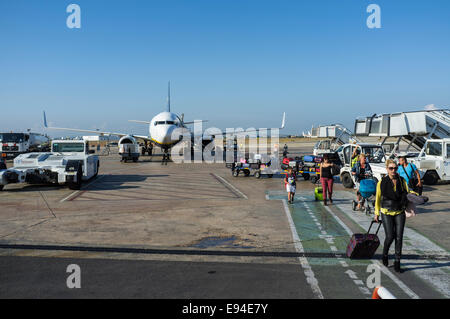 Passengers disembark by stairs from a Ryanair Boeing 737-800 at Valencia airport, Spain. Stock Photo