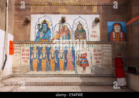Holy man and wall panting in the religious heart of  Varanasi, India Stock Photo