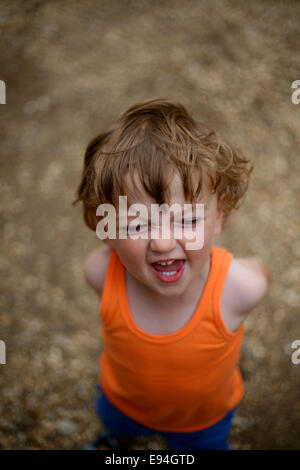 cheeky little boy laughing at camera Stock Photo
