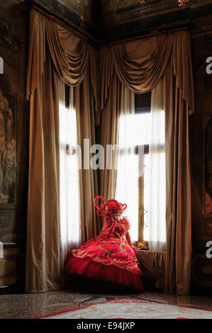 Carnevale Venice 2012. A costumed Carnival model in the centuries-old ballroom of a Venetian palace, now a hotel. Stock Photo