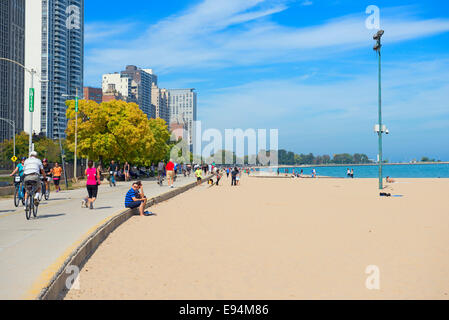 Oak Street Beach in Chicago and view of Lake Michigan, People and Bicycles Stock Photo