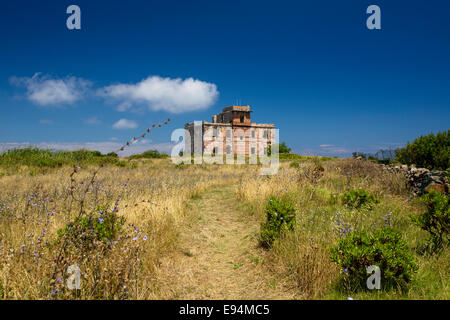 Abandoned outpost in the middle of a grassy field Stock Photo