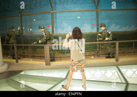 September 6, 2013, Seoul, South Korea -  Tourist photographs mannequins dressed as South Korean soldiers. Stock Photo