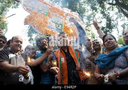 New Delhi. 19th Oct, 2014. Bharatiya Janata Party (BJP) supporters celebrate outside the BJP headquarters as Haryana and Maharashtra states assembly elections results come out in New Delhi, India on Oct.19, 2014. India's ruling BJP has won control of the country's financial capital Mumbai through a legislative election in the state of Maharashtra, while also grasping the northern state of Haryana from the Congress, said vote counting results Sunday. Credit:  Partha Sarkar/Xinhua/Alamy Live News Stock Photo