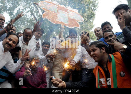 New Delhi. 19th Oct, 2014. Bharatiya Janata Party (BJP) supporters celebrate outside the BJP headquarters as Haryana and Maharashtra states assembly elections results come out in New Delhi, India on Oct.19, 2014. India's ruling BJP has won control of the country's financial capital Mumbai through a legislative election in the state of Maharashtra, while also grasping the northern state of Haryana from the Congress, said vote counting results Sunday. Credit:  Partha Sarkar/Xinhua/Alamy Live News Stock Photo