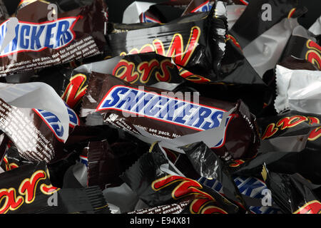 Tambov, Russian Federation - September 02, 2012 Empty sweet wrappers of Snickers and Mars minis candy bars heap. Stock Photo