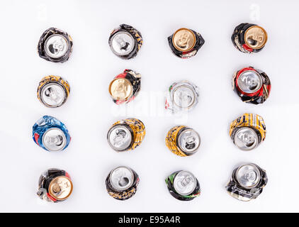 Crushed disposable beer drink cans aluminium on white table background  as tins recycling concept Stock Photo