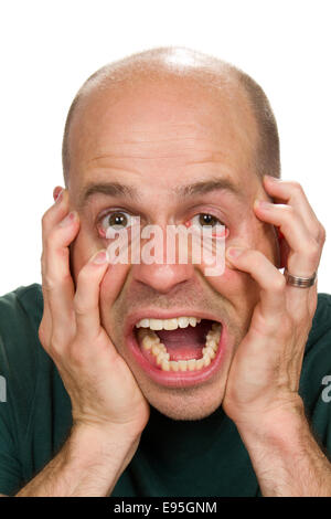 Stressed out man has reached his limit and claws at his face in distress. Stock Photo