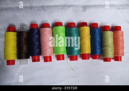 plastic reels with different colors cotton threads goods for sew Stock Photo