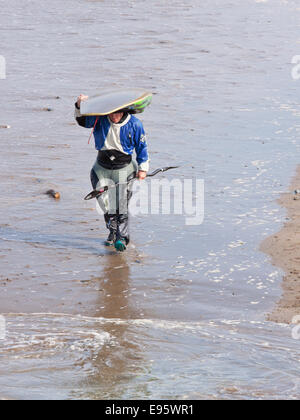 A lone body boarder on a North Devon beach returning to the shore Stock Photo