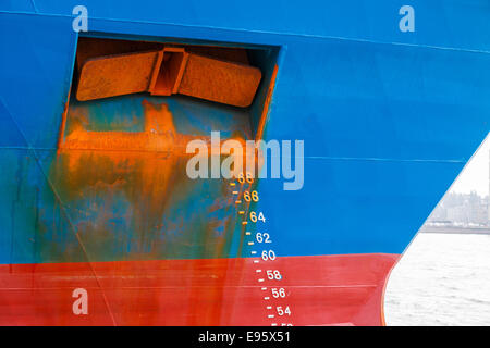 Large ship with draft scale and heavily rusted anchor on the bow Stock Photo