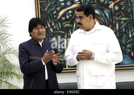 (141020) -- HAVANA, Oct. 20, 2014 (Xinhua) -- Bolivian President Evo Morales talks with his Venezuelan counterpart Nicolas Maduro(R)during the extraordinary Summit of the Bolivarian Alliance for the Peoples of Our America (ALBA), in Havana, Cuba, on Oct. 20, 2014. The summit slated for Monday was organized at requests by Director General of the World Health Organization (WHO) Margaret Chan, and UN Secretary General Ban Ki-moon as part of a global fight against the epidemic. The ALBA, which was founded in 2004, groups together Venezuela, Cuba, Nicaragua, Dominica, Antigua and Barbuda, Saint Luc Stock Photo