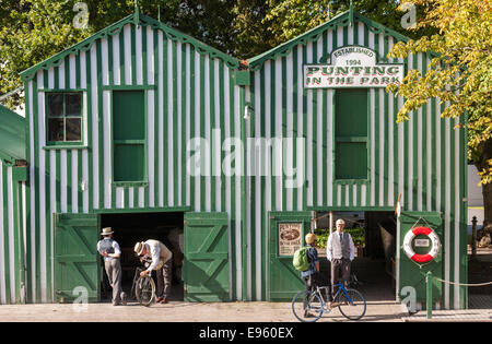 Christchurch Historic Antigua Boatsheds Boat sheds New Zealand Punting in the Park on the River Avon. Punters in traditional attire. Stock Photo