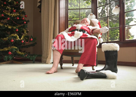 Santa resting after a long night delivering presents Stock Photo