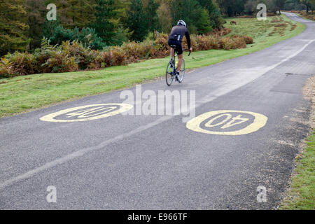 Cyclist riding in a 40 MPH speed limit zone on a deserted road in the New forest Hampshire UK