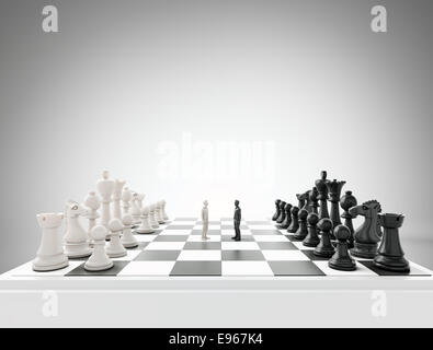 Two tiny figures standing on a chess board - conflict and competition concept illustration Stock Photo