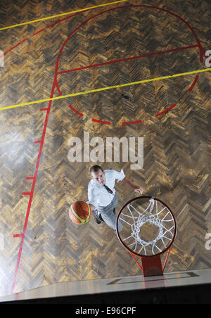 businessman holding basketball ball Stock Photo