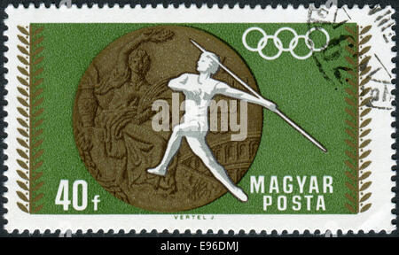 Stamp printed in Hungary, devoted to 19th Summer Olympics, Mexico City in 1968, shows the Olympic Medal and Women's Javelin Stock Photo