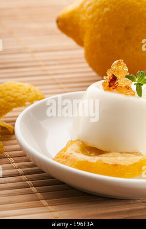 Vanilla Panna Cotta Dessert with lemon and fresh herbs Stock Photo