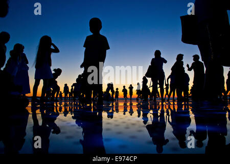 People reflections on colorful sunset