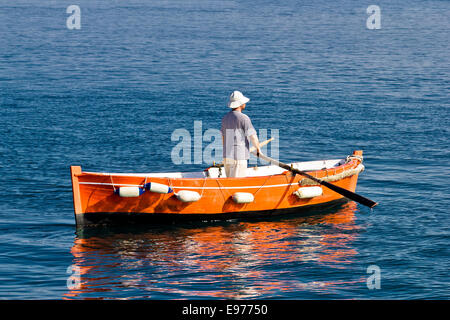 Sailor rowing on wooden taxi boat Stock Photo