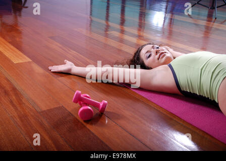 prety girl laying on back in fitness studio Stock Photo