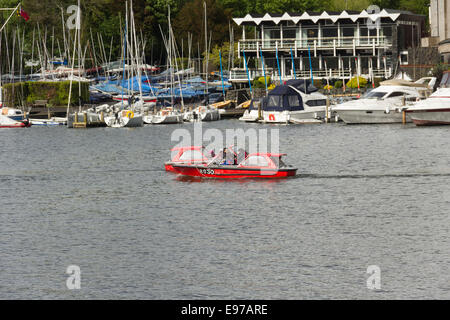 Two hire motor boats, on hire from Windermere Lake Crruises Ltd., passing close  to each other on Lake Windermere near Bowness. Stock Photo