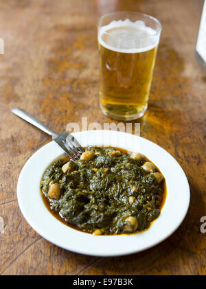 Bar and restaurant El Rinconcillo Seville's oldest, serves tapas as in the old days here kale with chickpeas Stock Photo
