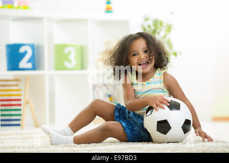 Kid girl playing toys at kindergarten room Stock Photo