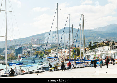 YALTA, RUSSIA - SEPTEMBER 28, 2014: people on waterfront in Yalta city in September . Yalta is resort city on the north coast of Stock Photo