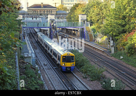 Denmark Hill railway station, south London. An Overground train pulls away. Shows new step-free access via lifts and footbridge Stock Photo