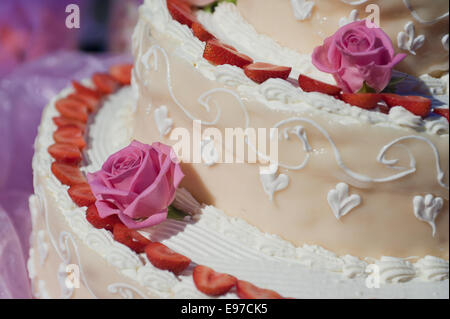 closeup of wedding cake, decorated with rose and strawberries Stock Photo