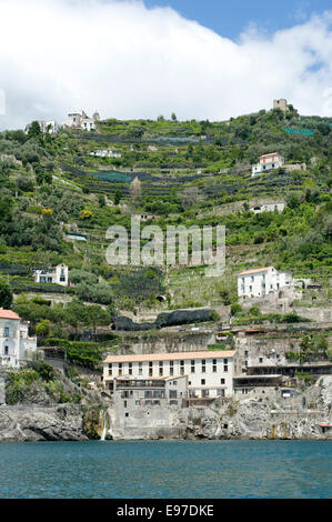 Villas, olives and lemon groves on the cliffs close to Amalfi from a boat in the Bay of Salerno in May Stock Photo